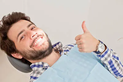 man showing off his smile after getting Invisalign